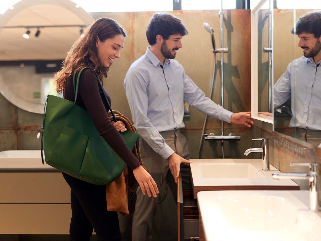 Couple shopping for bathroom appliances in a showroom